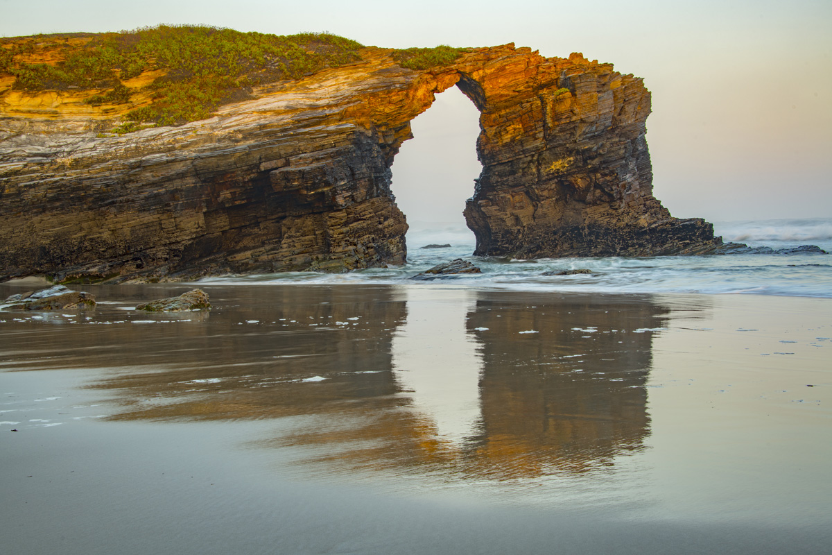 Sea Arch reflection, Cathedral Beach, Spain photographed by Tom Till