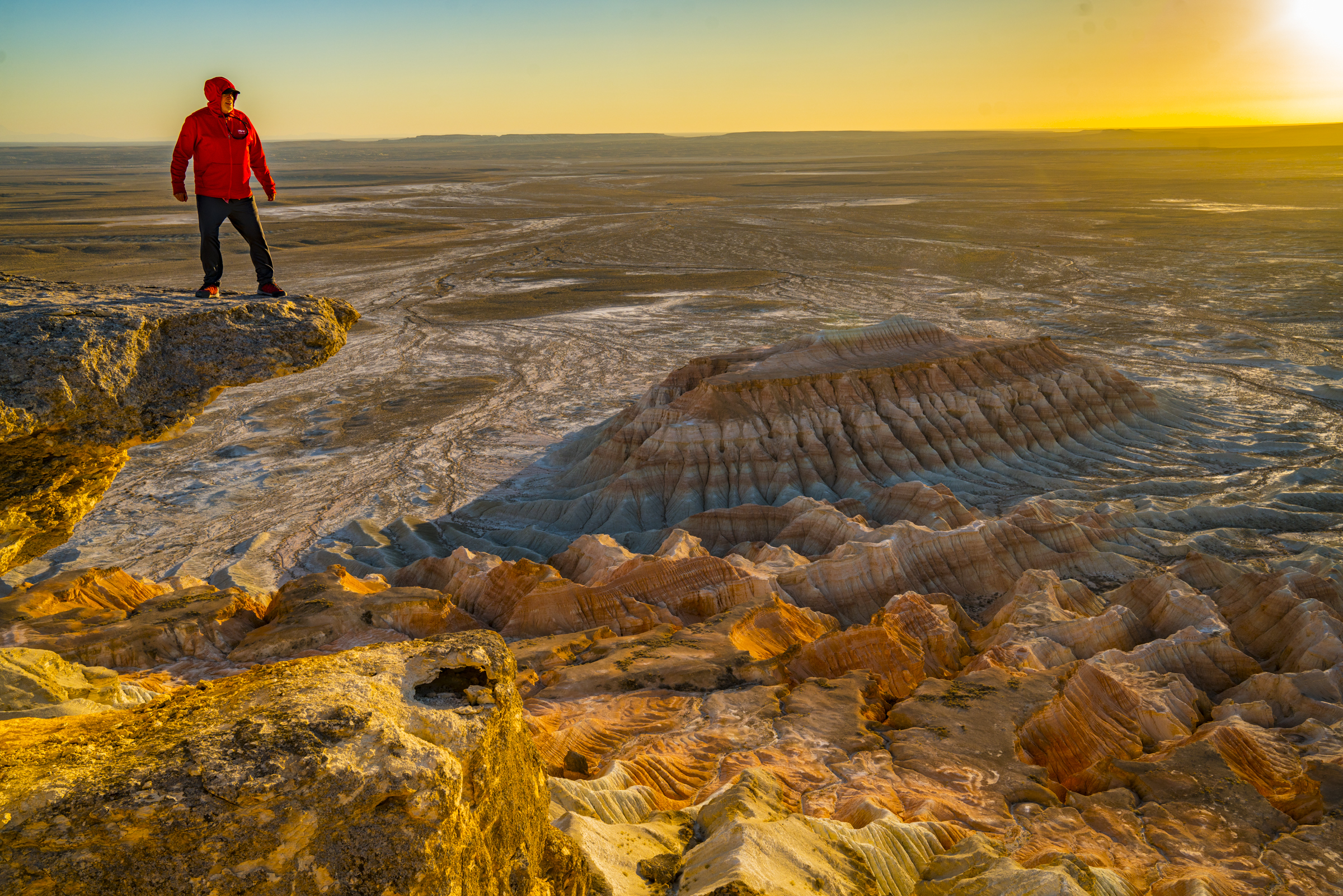 Hiker on precipce above Yangikala Canyon, Turkmenistan photographed by Tom Till